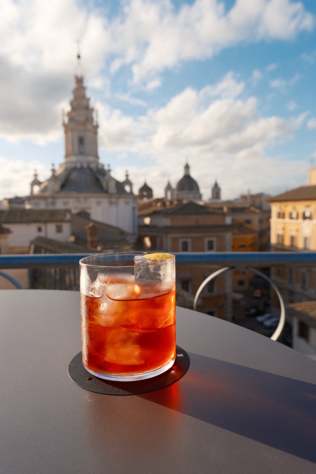 A sunlit Negroni on a rooftop overlooking Rome
