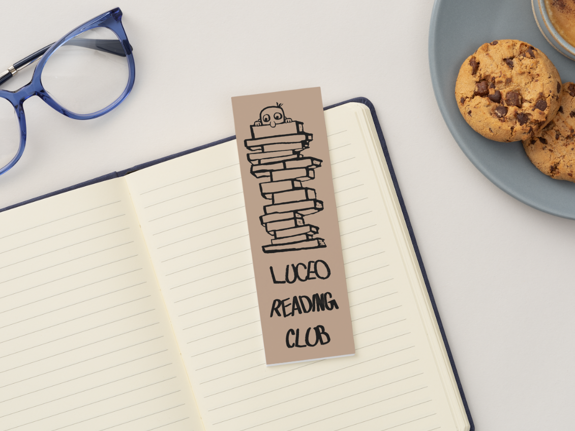 LUCEO bookmark on an open notebook beside glasses and biscuits