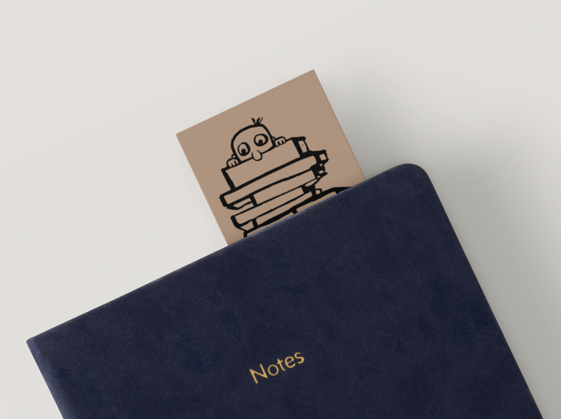 LUCEO Kid bookmark peeking out of a navy Notes book